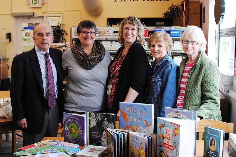 Cornelius Friends civic club donates Five members of the Friends standing together next to a book display